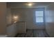Loft area featuring hard surface flooring, a large window, and neutral walls at 7253 Lacey Dr, Douglasville, GA 30134
