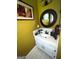 This bathroom features a round mirror, white vanity, and stylish fixtures at 520 Mcdonough Rd, Hampton, GA 30228