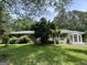 Charming brick ranch-style home featuring a sunroom and mature trees in a serene yard at 520 Mcdonough Rd, Hampton, GA 30228