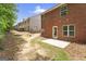 View of the backyard with a small concrete patio and red brick exterior at 2714 Haynescrest Dr, Grayson, GA 30017