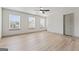 This bedroom is naturally lit with three windows and has hardwood floors at 2714 Haynescrest Dr, Grayson, GA 30017