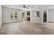 Open-concept living room with wood floors, ceiling fan, and kitchen view at 2714 Haynescrest Dr, Grayson, GA 30017