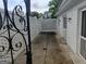 Enclosed backyard patio with white brick walls and iron gate at 7640 Ryefield Dr, Sandy Springs, GA 30350