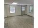Spacious finished basement with wood plank floors, natural light and outdoor access at 7640 Ryefield Dr, Sandy Springs, GA 30350