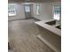 Open basement area with gray-toned flooring, natural light, and a bar, perfect for entertaining guests at 7640 Ryefield Dr, Sandy Springs, GA 30350