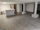 Finished basement with light wood-look floors, finished bar and support pillars at 7640 Ryefield Dr, Sandy Springs, GA 30350