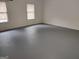 Large finished basement with painted concrete floors and ample natural light, providing versatile space for recreation or storage at 7640 Ryefield Dr, Sandy Springs, GA 30350