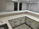Basement bar area with white cabinetry and a light-colored countertop, offering a stylish and functional space at 7640 Ryefield Dr, Sandy Springs, GA 30350