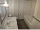 This bathroom offers a bright space with tile flooring and a toilet and shower to the right at 7640 Ryefield Dr, Sandy Springs, GA 30350