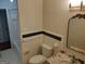 Bathroom featuring a vanity with a marble countertop, decorative mirror, toilet, and a tiled tub with a shower at 7640 Ryefield Dr, Sandy Springs, GA 30350
