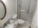 A clean bathroom features a toilet, shower, and marble-patterned sink at 7640 Ryefield Dr, Sandy Springs, GA 30350