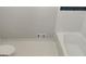 Cozy bathroom features a white tiled tub, toilet, and white hexagon-shaped tile flooring at 7640 Ryefield Dr, Sandy Springs, GA 30350