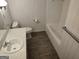 Bathroom features a vanity sink, and bathtub with shower at 7640 Ryefield Dr, Sandy Springs, GA 30350
