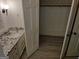Bathroom with a granite vanity and open closet space with wood-look floors at 7640 Ryefield Dr, Sandy Springs, GA 30350