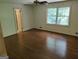 Bright bedroom with hardwood floors, a ceiling fan, and a large window at 7640 Ryefield Dr, Sandy Springs, GA 30350