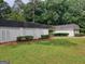 Well-maintained exterior with lush greenery and a white brick perimeter fence at 7640 Ryefield Dr, Sandy Springs, GA 30350