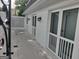 Covered porch entryway showing clean white brick and black metal outdoor lighting at 7640 Ryefield Dr, Sandy Springs, GA 30350