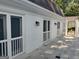 White brick home exterior with a covered porch entryway and black metal outdoor lighting at 7640 Ryefield Dr, Sandy Springs, GA 30350