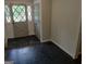 Foyer featuring a striking black tile floor and a classic paneled front door, blending functionality with timeless appeal at 7640 Ryefield Dr, Sandy Springs, GA 30350