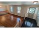 Open foyer with black tile floors leading into a living room with shiny hardwood floors at 7640 Ryefield Dr, Sandy Springs, GA 30350