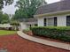 Inviting walkway leads to this home's front entrance, framed by manicured hedges at 7640 Ryefield Dr, Sandy Springs, GA 30350