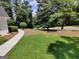 Well-maintained front yard with lush green grass and a curved sidewalk leading to the home at 7640 Ryefield Dr, Sandy Springs, GA 30350