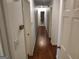 Hallway with hardwood floors, doors leading to bedrooms and bathrooms at 7640 Ryefield Dr, Sandy Springs, GA 30350