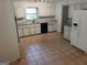Spacious kitchen with white cabinetry, granite countertops, and tile flooring at 7640 Ryefield Dr, Sandy Springs, GA 30350