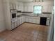 Functional kitchen with white cabinets, granite countertops, and modern appliances at 7640 Ryefield Dr, Sandy Springs, GA 30350