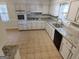 Bright kitchen featuring white cabinetry, granite countertops, and stainless steel appliances at 7640 Ryefield Dr, Sandy Springs, GA 30350