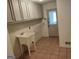 Functional laundry room with a utility sink, cabinets, and easy access outside at 7640 Ryefield Dr, Sandy Springs, GA 30350