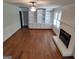 Living room featuring wood floors, built-in shelving and a fireplace at 7640 Ryefield Dr, Sandy Springs, GA 30350