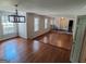 Open-concept living room featuring hardwood floors, large windows, and elegant lighting at 7640 Ryefield Dr, Sandy Springs, GA 30350