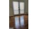 Patio doors with horizontal blinds, flooding the hardwood floors with natural light at 7640 Ryefield Dr, Sandy Springs, GA 30350