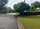 Scenic street view showcasing mature landscaping and the home's inviting neighborhood at 7640 Ryefield Dr, Sandy Springs, GA 30350