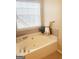 Bathroom featuring a soaking tub with stylish tile surround and a modern faucet at 2517 Walter Way, Stockbridge, GA 30281