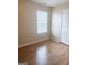 Bedroom featuring wood-look floors and a window with blinds for adjustable lighting at 2517 Walter Way, Stockbridge, GA 30281