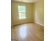 Bright bedroom featuring wood-look floors and a large window offering natural light at 2517 Walter Way, Stockbridge, GA 30281