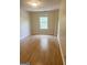 Bright bedroom featuring wood-look floors, a window with natural light, and neutral walls at 2517 Walter Way, Stockbridge, GA 30281