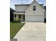 Two-story home with a two-car garage, lawn, and landscaped front entrance at 2517 Walter Way, Stockbridge, GA 30281