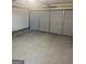 Empty two car garage with concrete floors and gray doors at 2517 Walter Way, Stockbridge, GA 30281