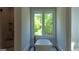 Bathroom with freestanding tub, window, and marble-tiled shower at 10765 Shallowford Rd, Roswell, GA 30075