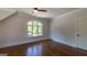 Bedroom with an arched window, hardwood flooring, and ceiling fan at 10765 Shallowford Rd, Roswell, GA 30075