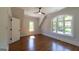 Bedroom with an arched window, natural light, and beautiful hardwood flooring at 10765 Shallowford Rd, Roswell, GA 30075