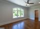 Spacious bedroom with hardwood floors and a large window at 10765 Shallowford Rd, Roswell, GA 30075