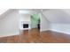 Spacious bonus room features a fireplace, hardwood floors, and white trim at 10765 Shallowford Rd, Roswell, GA 30075