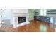 Bonus room with fireplace, wet bar with wine cooler, and hardwood flooring at 10765 Shallowford Rd, Roswell, GA 30075