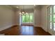 Elegant dining room featuring hardwood floors, a modern chandelier, large window and decorative trim at 10765 Shallowford Rd, Roswell, GA 30075