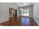 Elegant dining room featuring hardwood floors, detailed trim, a modern chandelier and ample natural light at 10765 Shallowford Rd, Roswell, GA 30075