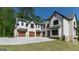 Spacious home with a three-car garage and ample driveway space, perfect for car enthusiasts or large families at 10765 Shallowford Rd, Roswell, GA 30075